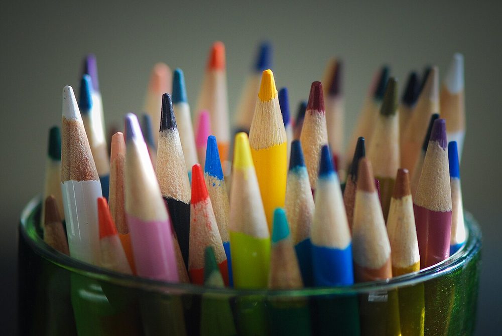 A pot full of coloured pencils
